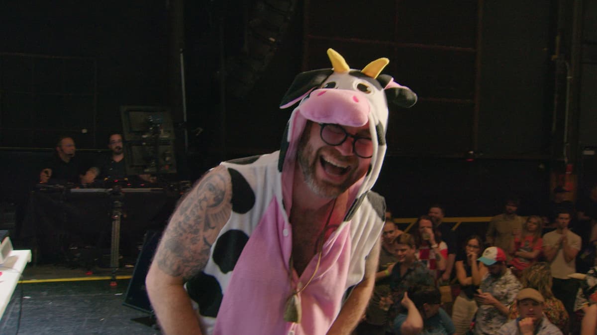 Cheesemonger in cow costume celebrating